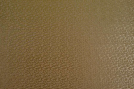 Texture of golden satin fabric with abstract embossing.の写真素材