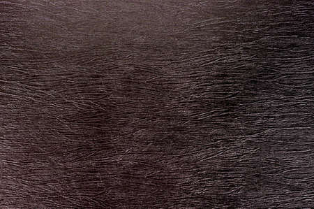 Texture of crumpled dark brown imitation leather.の写真素材