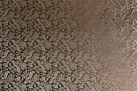 Texture of bronze satin fabric with floral embossing.の写真素材