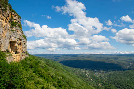 View of a beautiful rocky mountain, blue sky and clouds on a sunny day. Wonderful summer landscape in the mountains. Grassy field and gentle hills. rural landscape. selective focus.の写真素材