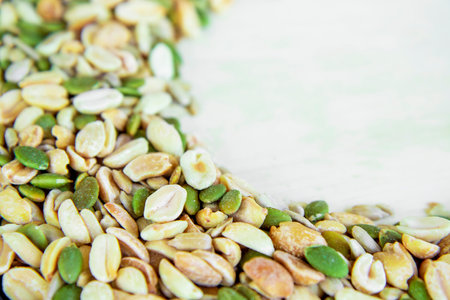 Top view of a mixture of various nuts: sunflower seeds, pumpkin and peanuts. Vegan. Healthy vegetable fats. The concept of healthy nutrition and fitness diet. Selective focus and blurred background.の写真素材