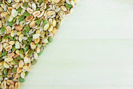 a mixture of various nuts: sunflower seeds, pumpkin and peanuts. Vegan food. Healthy vegetable fats. The concept of healthy nutrition and fitness diet. Space for text. selective focus.の写真素材