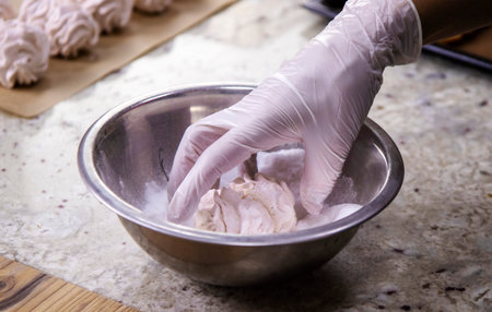 The pastry chef's hand in close-up. Fragrant and fresh marshmallows made from natural ingredients . The concept of delicious and healthy desserts.の写真素材