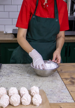 view of a pastry chef's woman busy making marshmallows from natural and healthy ingredients. The concept of delicious and dietary desserts.の写真素材