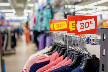A red stand with a big discount at the mall. Advertising clothes on Black Friday.The concept of a...