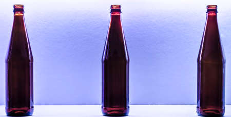 Three small bottles on a weak lilac backgroundの写真素材