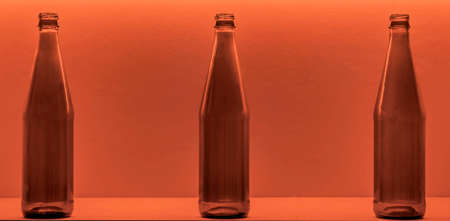 Three small bottles on a brown backgroundの写真素材