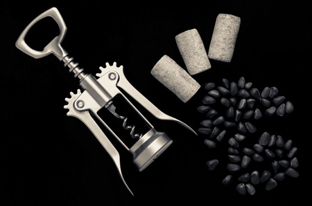 Coffee grains pine nuts corkscrew and cork on the backgroundの写真素材