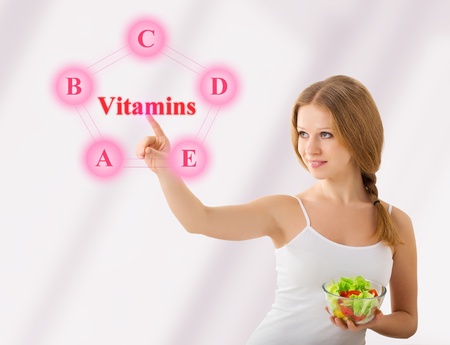 beautiful girl  with  salad choose healthy foods rich in vitaminsの写真素材