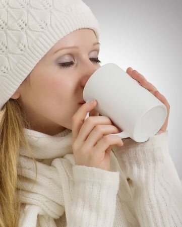 beautiful girl in winter clothes drinking  drinkの写真素材