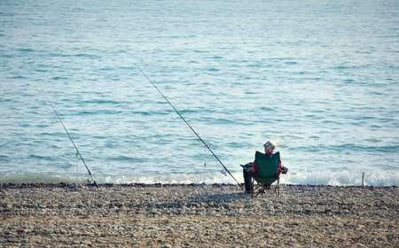 fisherman with a fishing rod fishing の写真素材