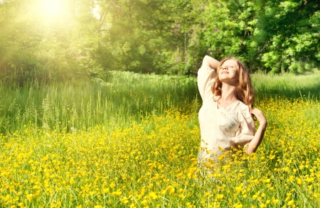 beautiful girl enjoying the summer sun outdoorsの写真素材