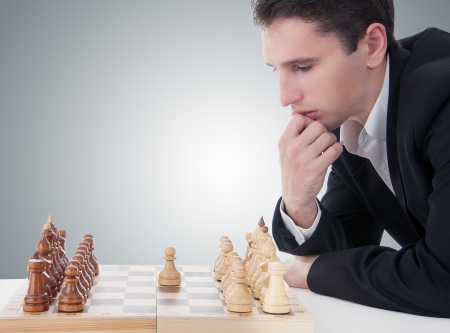 business man playing chess, making the first moveの写真素材