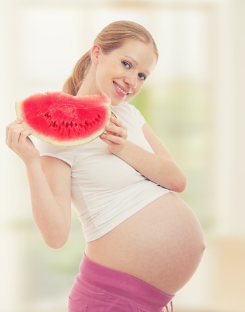 Pregnancy and a healthy food. pregnant woman with watermelonの写真素材