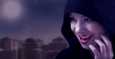 beautiful witch in a black hood on the day of Halloweenの写真素材