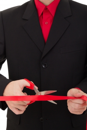 grand opening ceremony. man cutting the red ribbon with scissorsの写真素材