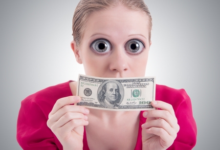 money concept. woman with a big surprise open eyes and mouth closed dollarの写真素材