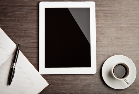 empty tablet and a cup of coffee on the deskの写真素材