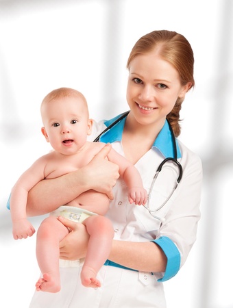 Pediatrician woman doctor holding in his arms patient babyの写真素材