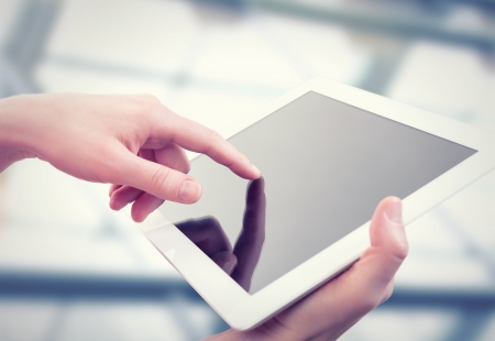 white tablet with a  blank empty screen in the hands の写真素材