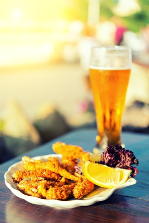 glass of beer and fishの写真素材