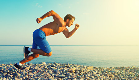 man athlete running by the sea at sunset outdoors
