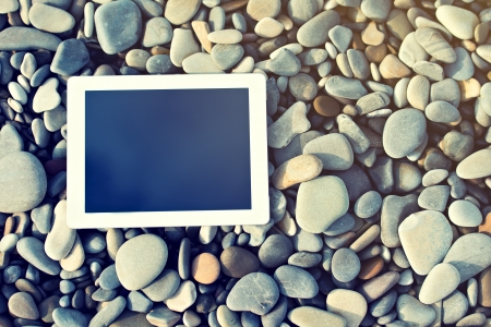 concept of internet and communication. blank empty tablet computer on the beachの写真素材
