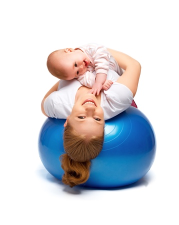 A mother and baby doing gymnastic exercises on the ballの写真素材
