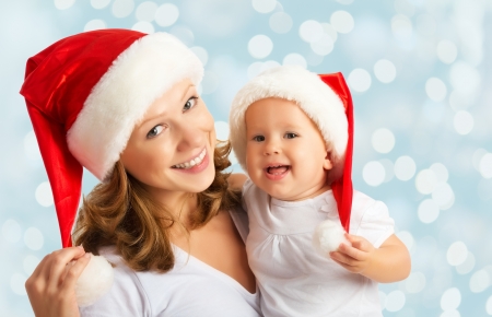 happy family mother and baby in red Christmas hatsの写真素材