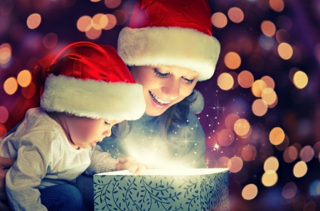 Christmas magic gift box and a woman happy family mother and Child babyの写真素材