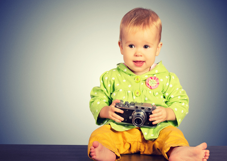 Beauty baby girl photographer with retro cameraの写真素材