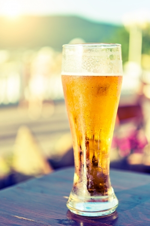 glass of beer on a table in a barの写真素材