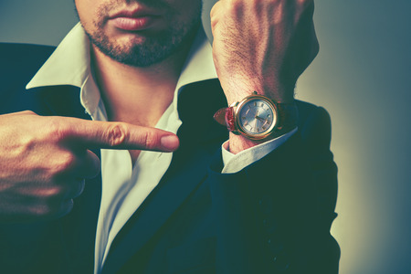 concept of time. watches on the arm of stylish businessmanの写真素材