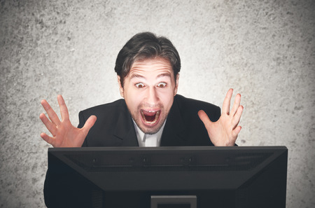 young busines man screaming at the computer, emotion, expressionの写真素材
