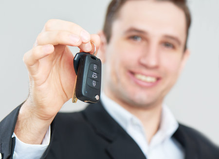The business happy man holding car keys