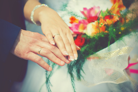 the wedding, the bride and groom hand in engagement ringsの写真素材