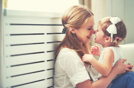 Happy loving family. mother and child girl playing, kissing and hugging