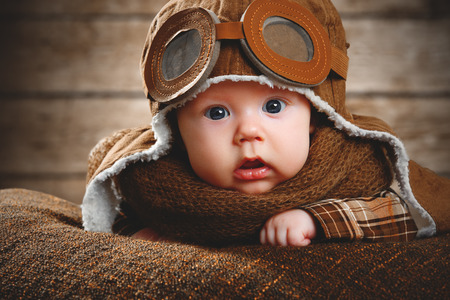 cute pilot aviator baby newborn in brown colorの写真素材