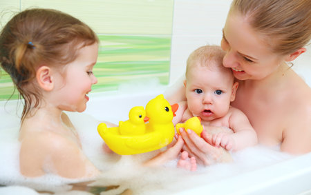 bathing in a bath with foam mother together children baby
