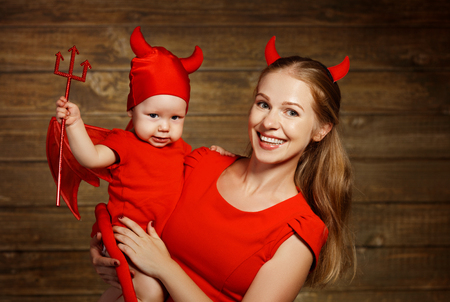 Family fun mother and baby son having fun and celebrate Halloween in devil costumeの写真素材