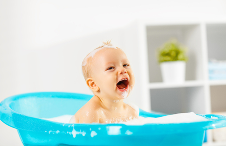 A Happy toddler bathing in bathtubの写真素材