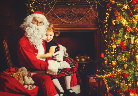 happy child girl hugging Santa and laughsの写真素材