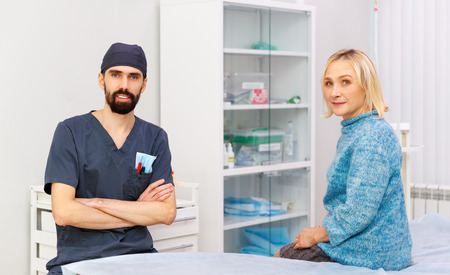 friendly doctor and an old patient in a clinicの写真素材