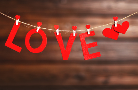background Valentine's day. two red hearts and the word Love on the wooden backgroundの写真素材