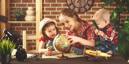 Happy family of mother and children prepareto  travel trip, learn for route mapの写真素材