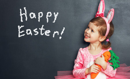 Happy easter! Child girl with bunny ears and eggs.の写真素材