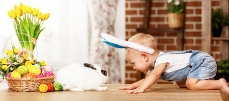 happy easter! happy funny baby boy playing with Easter bunny