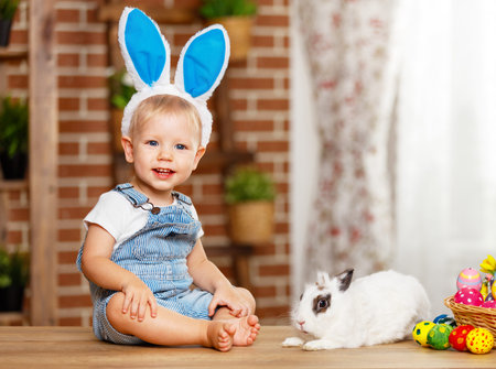 happy easter! happy funny baby boy playing with Easter bunny
