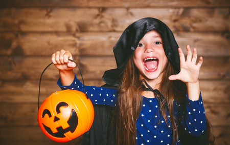 Laughing funny child girl in a witch costume in halloween
の写真素材
