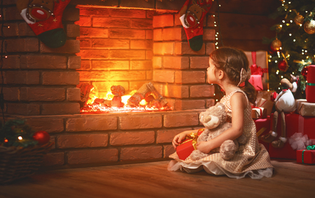 happy   child girl with christmas gift at evening home
の写真素材